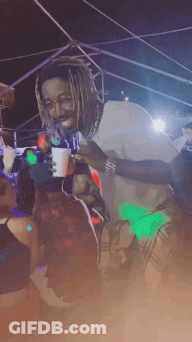 Man With Dreadlocks Holding Cup In Crowd GIF