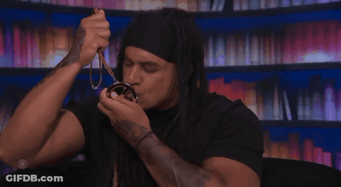 Man With Dreadlocks Holding Keanu Medal GIF