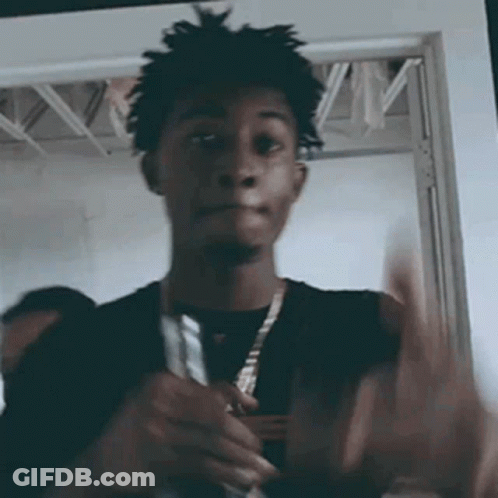 Man With Dreadlocks Holding Knife In Front Of Door GIF