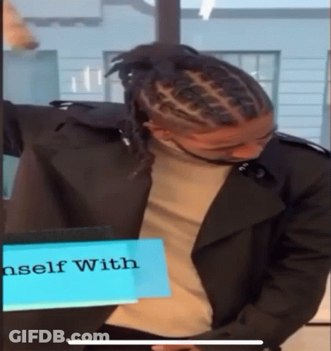 Man With Dreadlocks In Front Of Sign Saying Self With GIF
