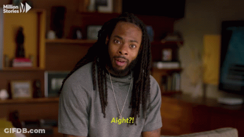 Man With Dreadlocks In Grey Shirt Saying Aight GIF
