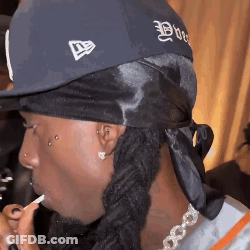 Man With Dreadlocks In New Era Hat GIF