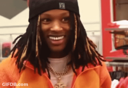 Man With Dreadlocks In Orange Jacket And Black Beanie GIF