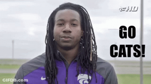 Man With Dreadlocks In Purple Jacket Says Go Cats GIF