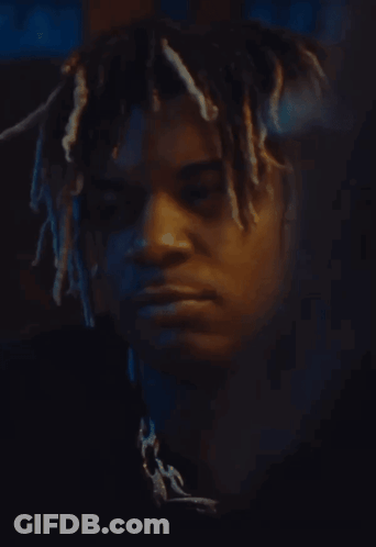 Man With Dreadlocks Looking At Camera GIF