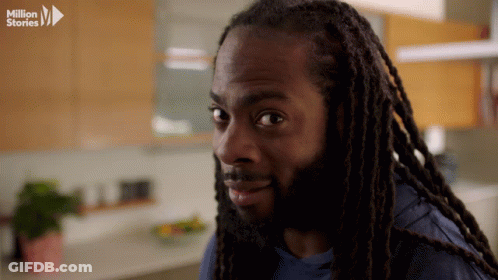 Man With Dreadlocks Looking At Camera With Million Stories Logo GIF