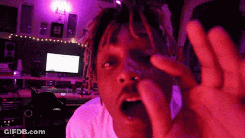 Man With Dreadlocks Making Funny Face Under Purple Lights GIF