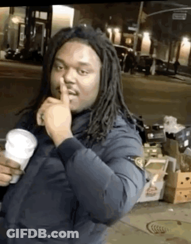 Man With Dreadlocks Making Shhh Gesture GIF