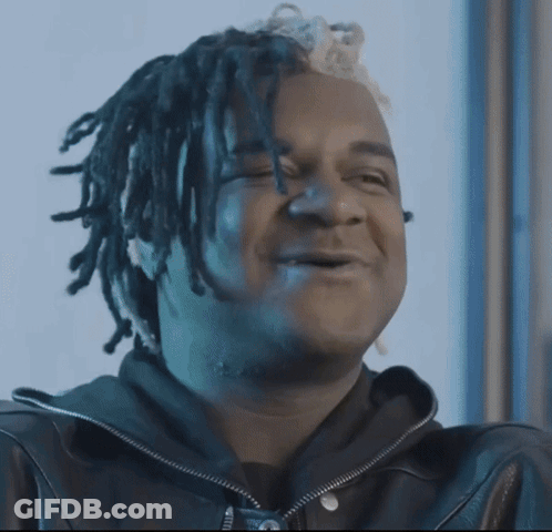 Man With Dreadlocks On Couch Holding Money Bag GIF