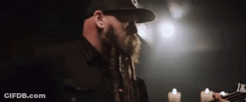 Man With Dreadlocks Playing Guitar GIF