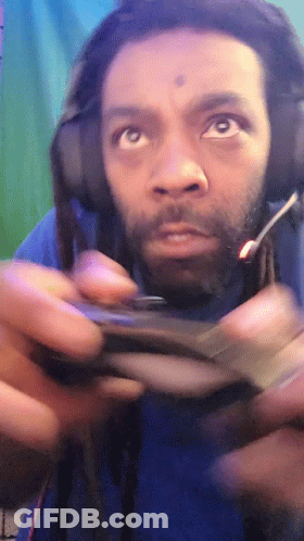 Man With Dreadlocks Playing Video Game With Headphones GIF
