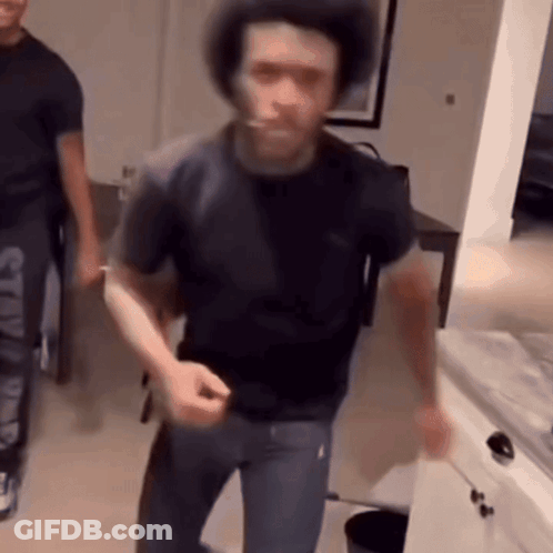 Man With Dreadlocks Raising Arm GIF
