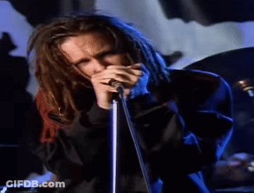 Man With Dreadlocks Singing Into Microphone GIF