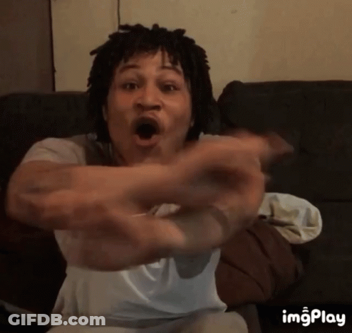 Man With Dreadlocks Sitting On Couch Arms Outstretched GIF