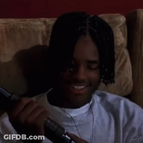 Man With Dreadlocks Sitting On Couch Looking GIF