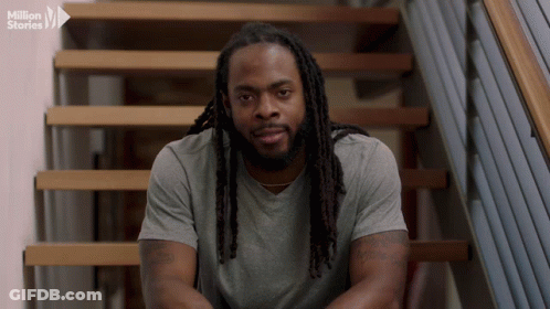 Man With Dreadlocks Sitting On Stairs Million Stories Logo GIF
