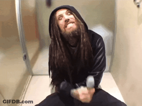 Man With Dreadlocks Sitting On Toilet Making Funny Face GIF