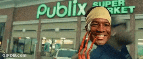 Man With Dreadlocks Smiling In Front Of Publix Super Market GIF