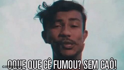 Man With Dreadlocks Smoking Cigarette In Dark Room GIF