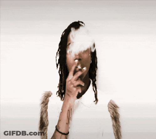 Man With Dreadlocks Smoking Cigarette Smoke From Nose GIF