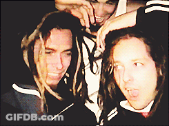 Man With Dreadlocks Standing Next To Two Men GIF