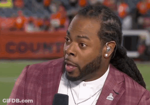 Man With Dreadlocks Talking Into Microphone On Football Field GIF