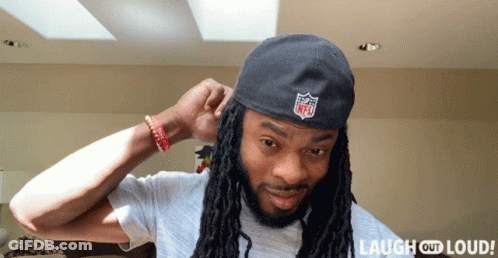 Man With Dreadlocks Wearing NFL Logo Hat GIF