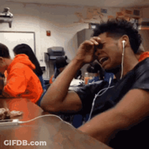 Man With Ear Buds Crying In Classroom GIF