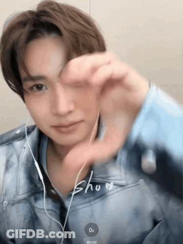 Man With Earbuds Making Heart With Hand GIF