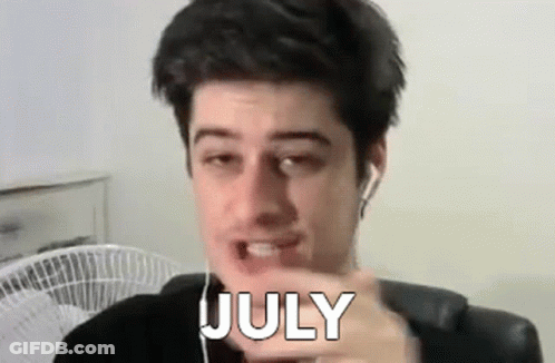 Man With Earbuds Pointing At Camera Word July GIF