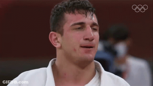 Man With Eyes Closed And Olympics Logo GIF