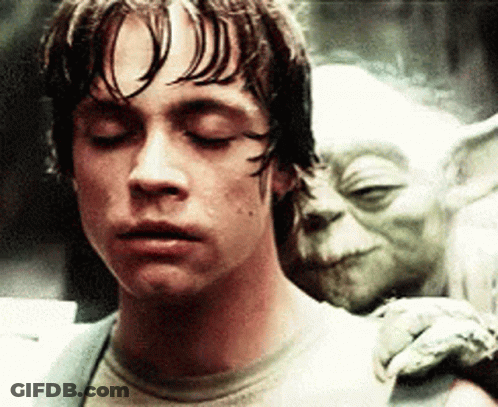 Man With Eyes Closed And Yoda Statue GIF
