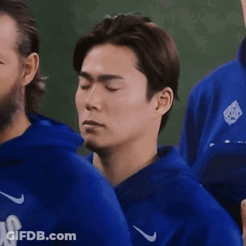 Man With Eyes Closed In Blue Nike Jacket GIF