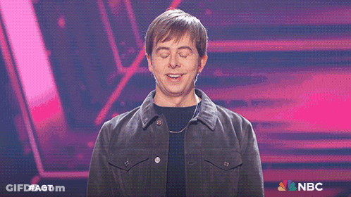 Man With Eyes Closed In Front Of Screen Saying NBC GIF