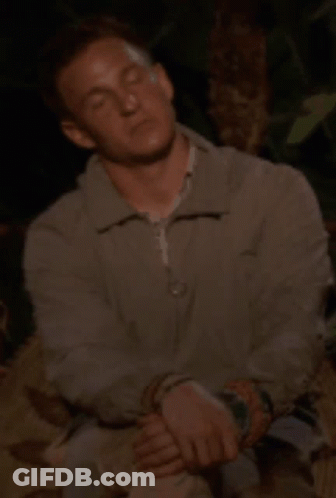 Man With Eyes Closed In Grey Jacket GIF