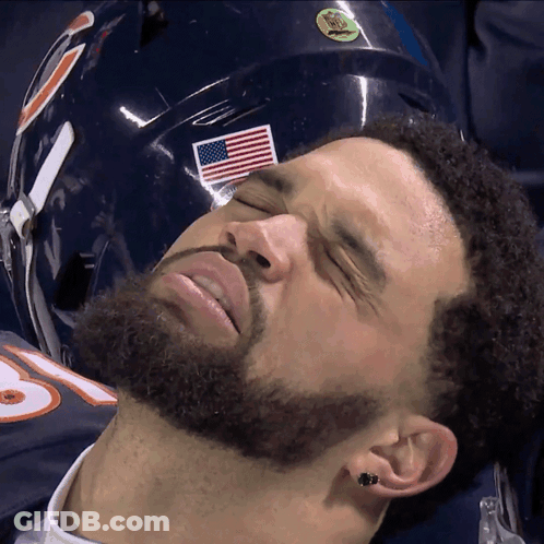 Man With Eyes Closed Lying Next To American Flag Helmet GIF