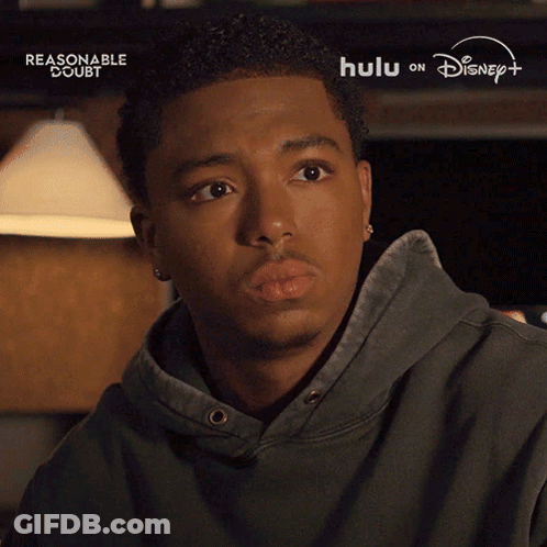 Man With Eyes Closed Says Alright In Front Of Disney Logo GIF