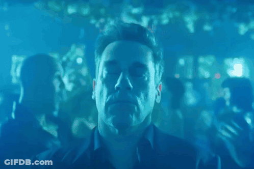 Man With Eyes Closed Surrounded By Blue Lights GIF