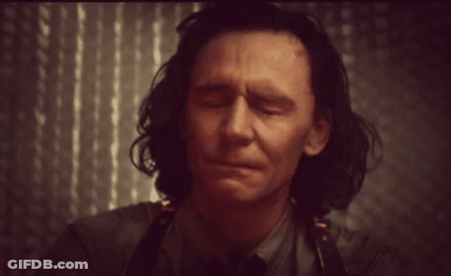 Man With Eyes Closed Wearing Apron And Tie GIF
