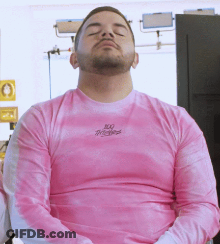 Man With Eyes Closed Wearing Pink 100 Thieves Shirt GIF