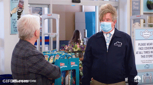 Man With Face Mask Talking To Another Man GIF