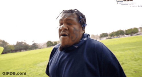 Man With Face Tattoo In Grassy Field GIF
