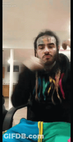 Man With Face Tattoo In Hoodie Saying X GIF