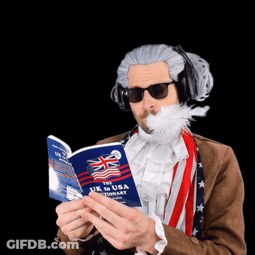Man With Feather Reading UK To USA Dictionary GIF