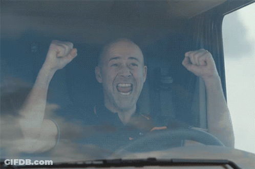 Man With Fist In Air Driving Truck GIF