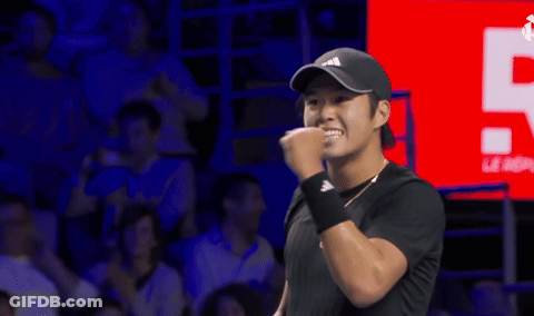 Man With Fist In Air Wearing Black Adidas Hat GIF