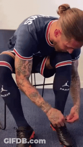 Man With Forehead Tattoo Tying Shoes GIF