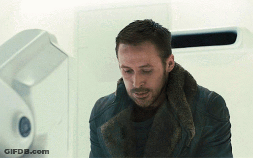 Man With Fur Collar Looking Down GIF