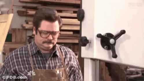Man With Glasses And Apron At Band Saw GIF