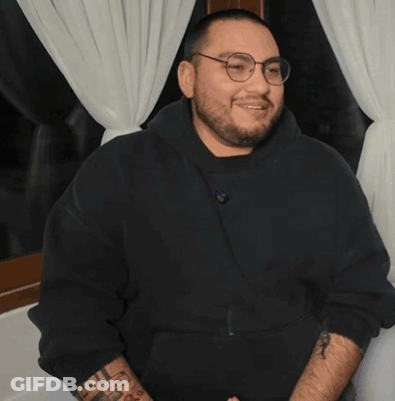 Man With Glasses And Arm Tattoo Covering Mouth GIF